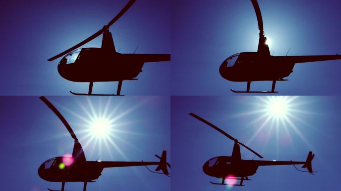 飞行中的直升机空中飞机转动起飞阳光直射下