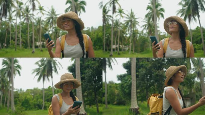 亚洲年轻女子探索椰子林，使用智能手机导航