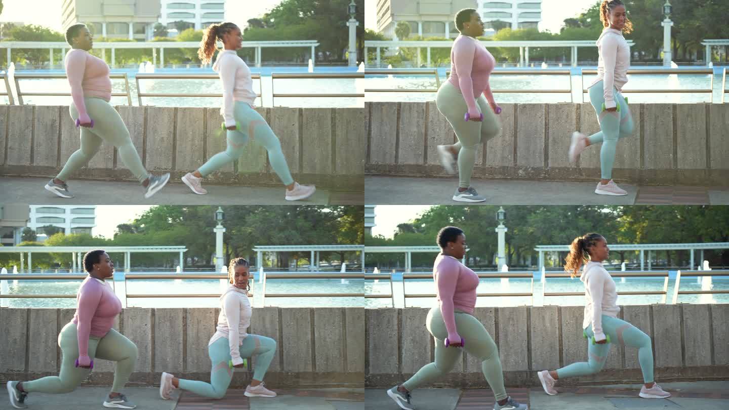 两名非裔美国妇女在城市公园做弓箭步