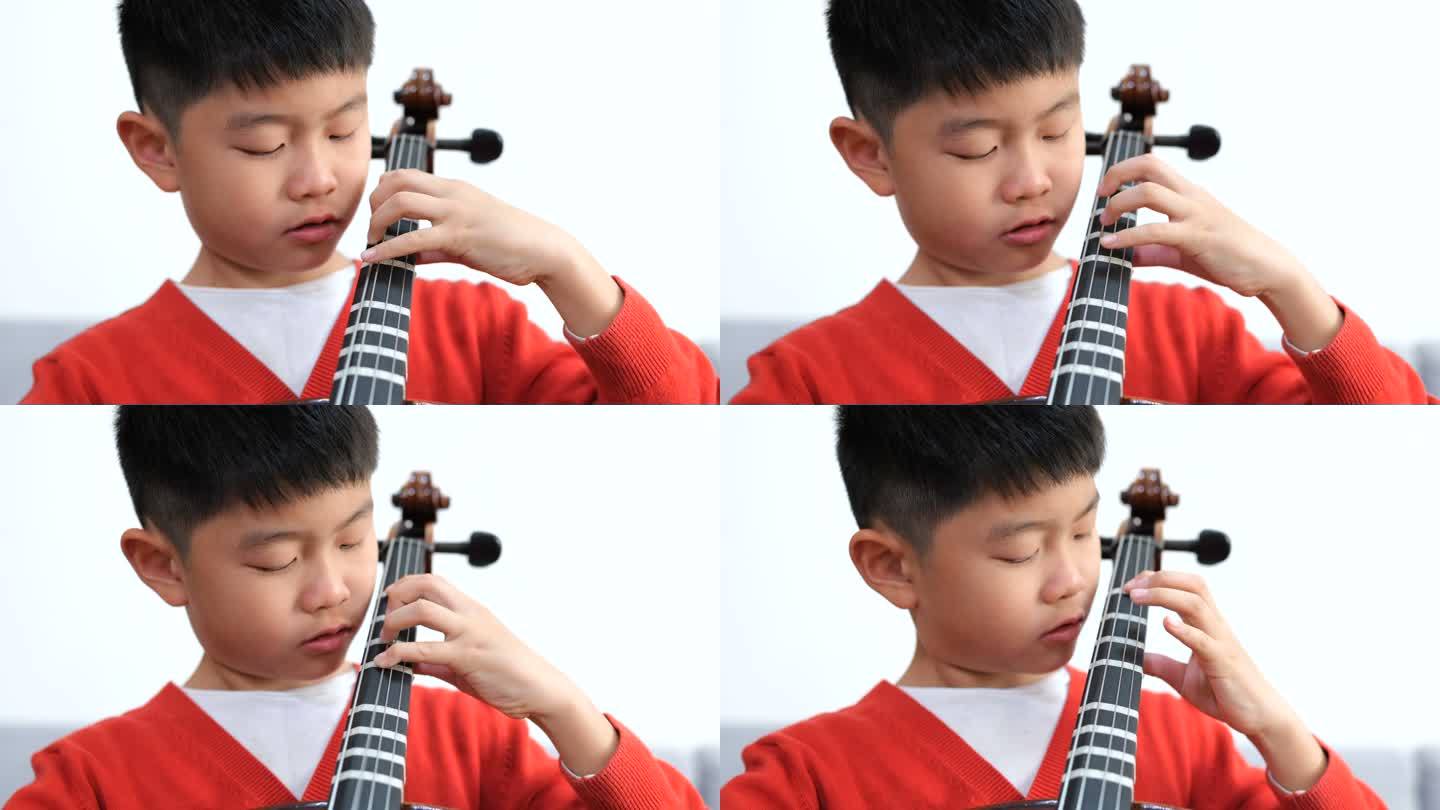 小男孩在家练习大提琴