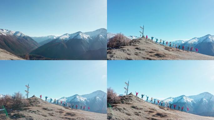 航拍一群人站在雪山对面的山坡上
