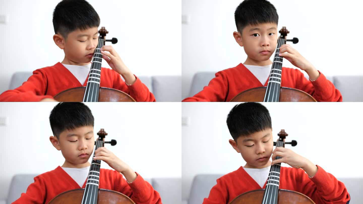 小男孩在家练习大提琴