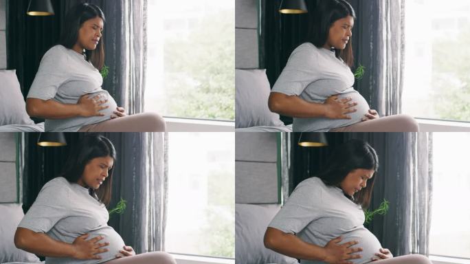 一名年轻孕妇在家中经历宫缩的4k视频片段
