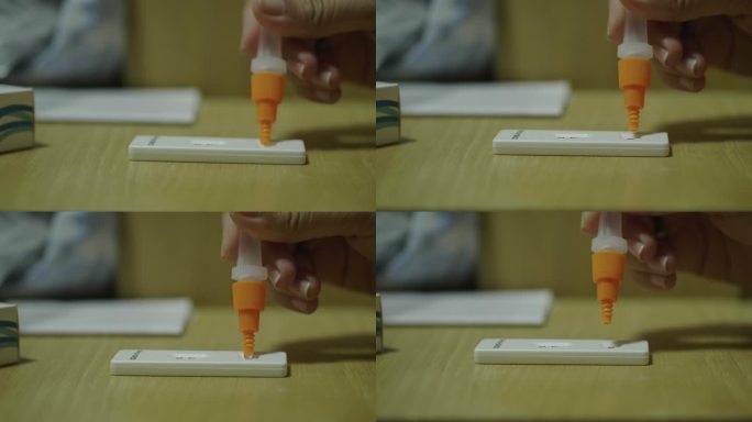 一名亚洲妇女使用棉签来保存样本，以检查新冠肺炎冠状病毒。