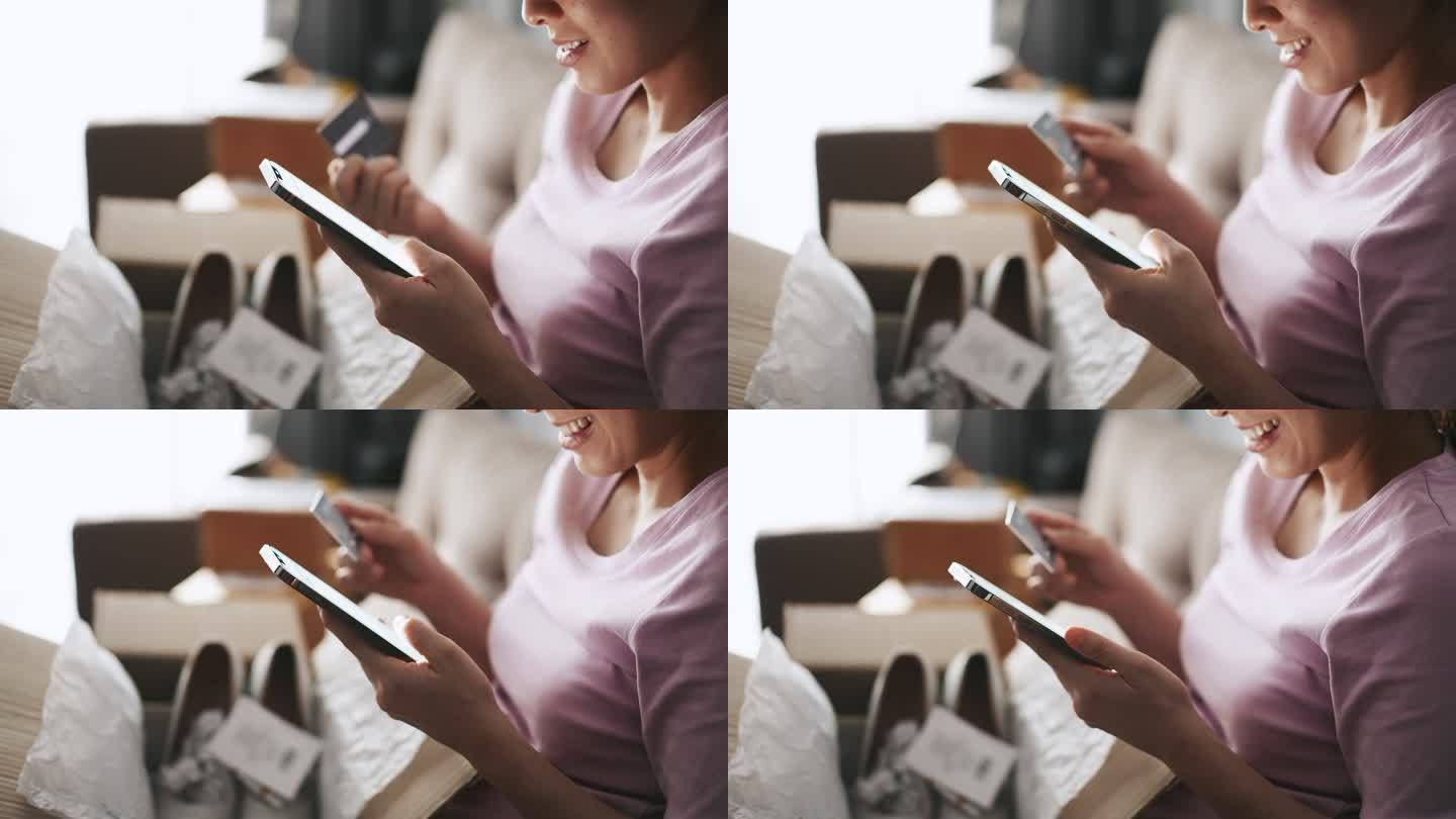亚洲女子网购时在手机上输入PIN码并在家中持有信用卡