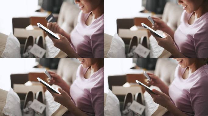 亚洲女子网购时在手机上输入PIN码并在家中持有信用卡