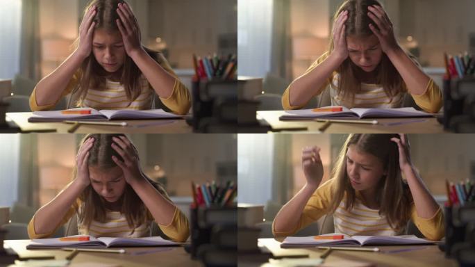 一个年轻女孩独自坐在家里，做作业时感到压力重重的4k视频片段