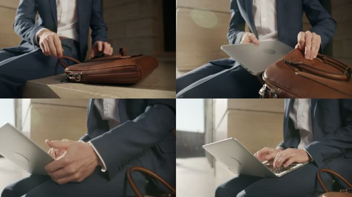 一位年轻迷人的金发商人坐在现代建筑立面的石头上，拿起笔记本电脑皮包，拿出笔记本电脑放在膝盖上
