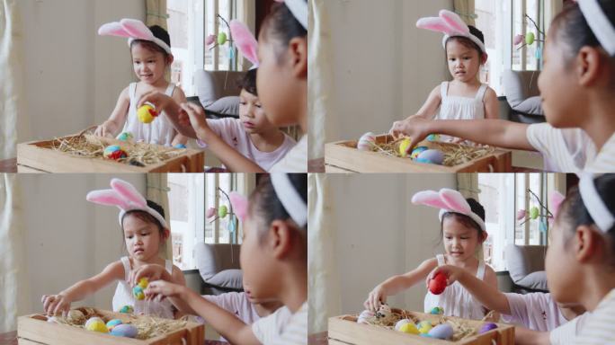 一群戴着兔子头带的亚洲孩子正在一起把画好的鸡蛋放进篮子里。孩子和朋友为复活节做准备和装饰。