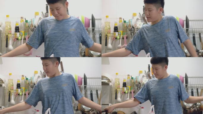 在家煮自制焦糖爆米花时跳舞的亚洲男孩，生活方式理念。
