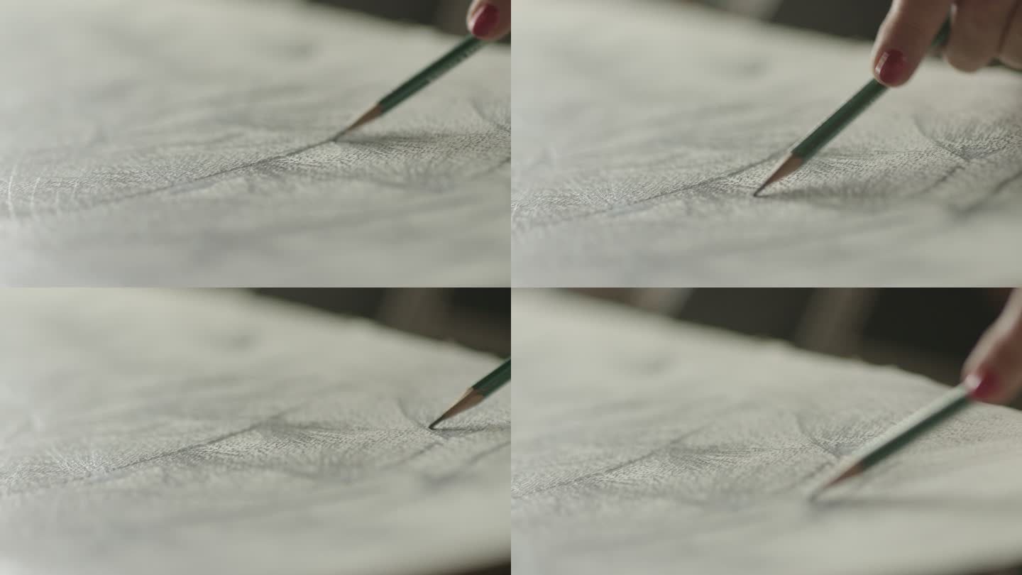 艺术家用木笔在白纸上作画。