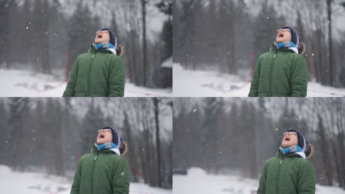 青少年男孩在冬天吃雪