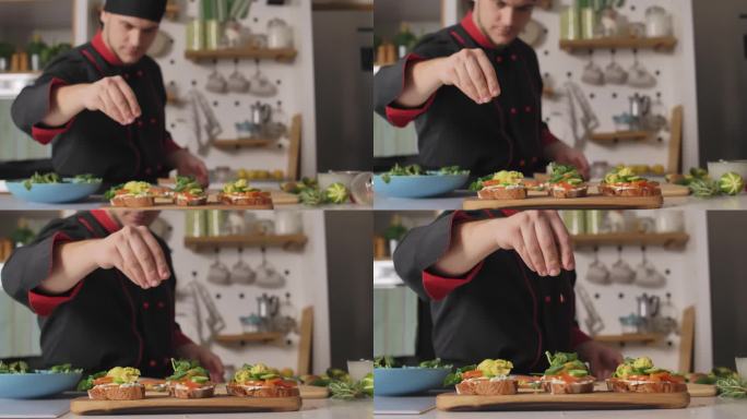 厨师在三明治上加一小撮葵花籽的选择性焦点镜头