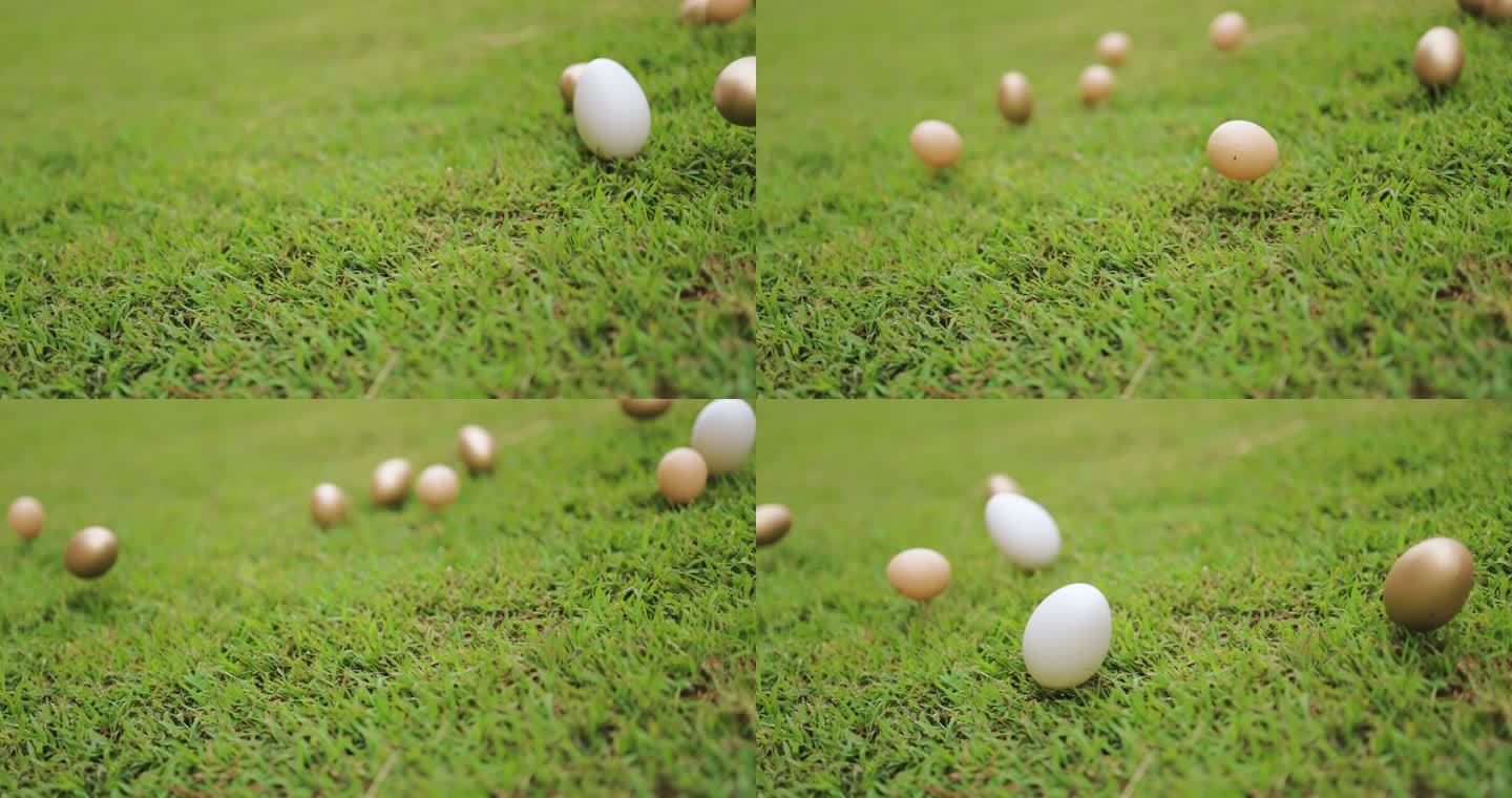 复活节彩蛋在绿草上滚动