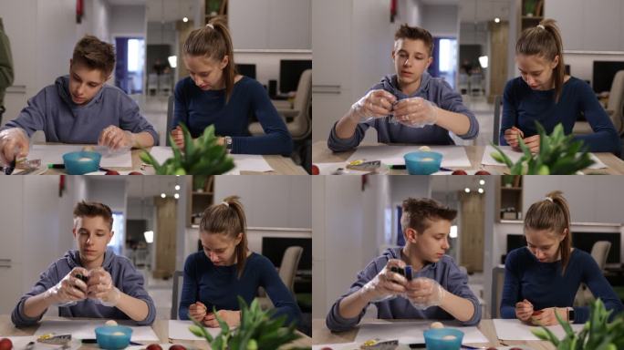 青少年儿童为复活节绘画和制作彩蛋