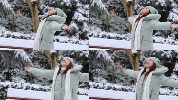享受下雪冬日的年轻女子