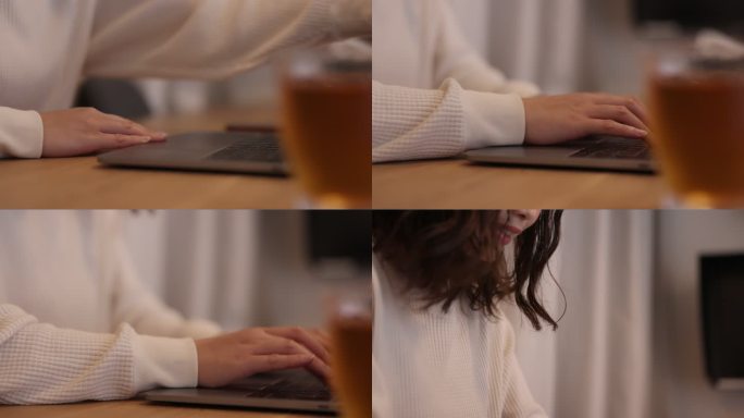 在工作室工作的女士，桌上放着一杯茶和笔记本电脑