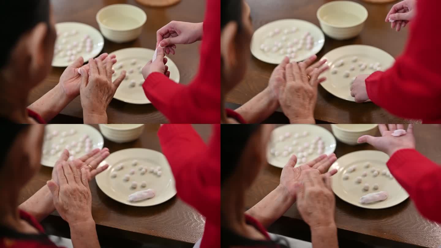 一位亚洲祖母和她的孙女正在准备为中国新年庆祝做汤圆