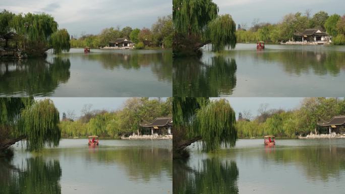 扬州瘦西湖阴雨天在雨中行驶中摇橹船船娘