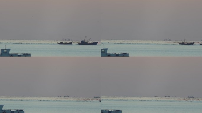 2条渔船驶过夕阳下的海面