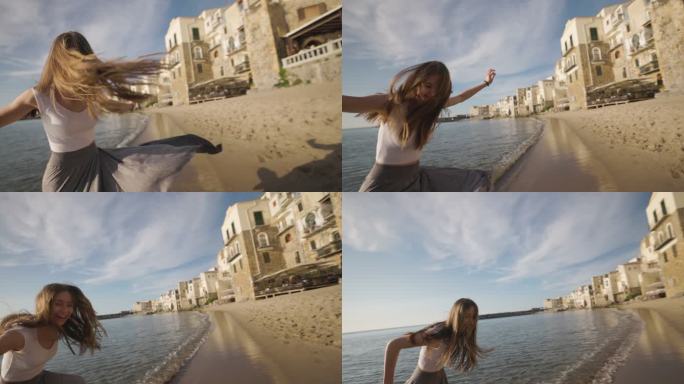 在塞法鲁老城的海滩上跳舞的少女