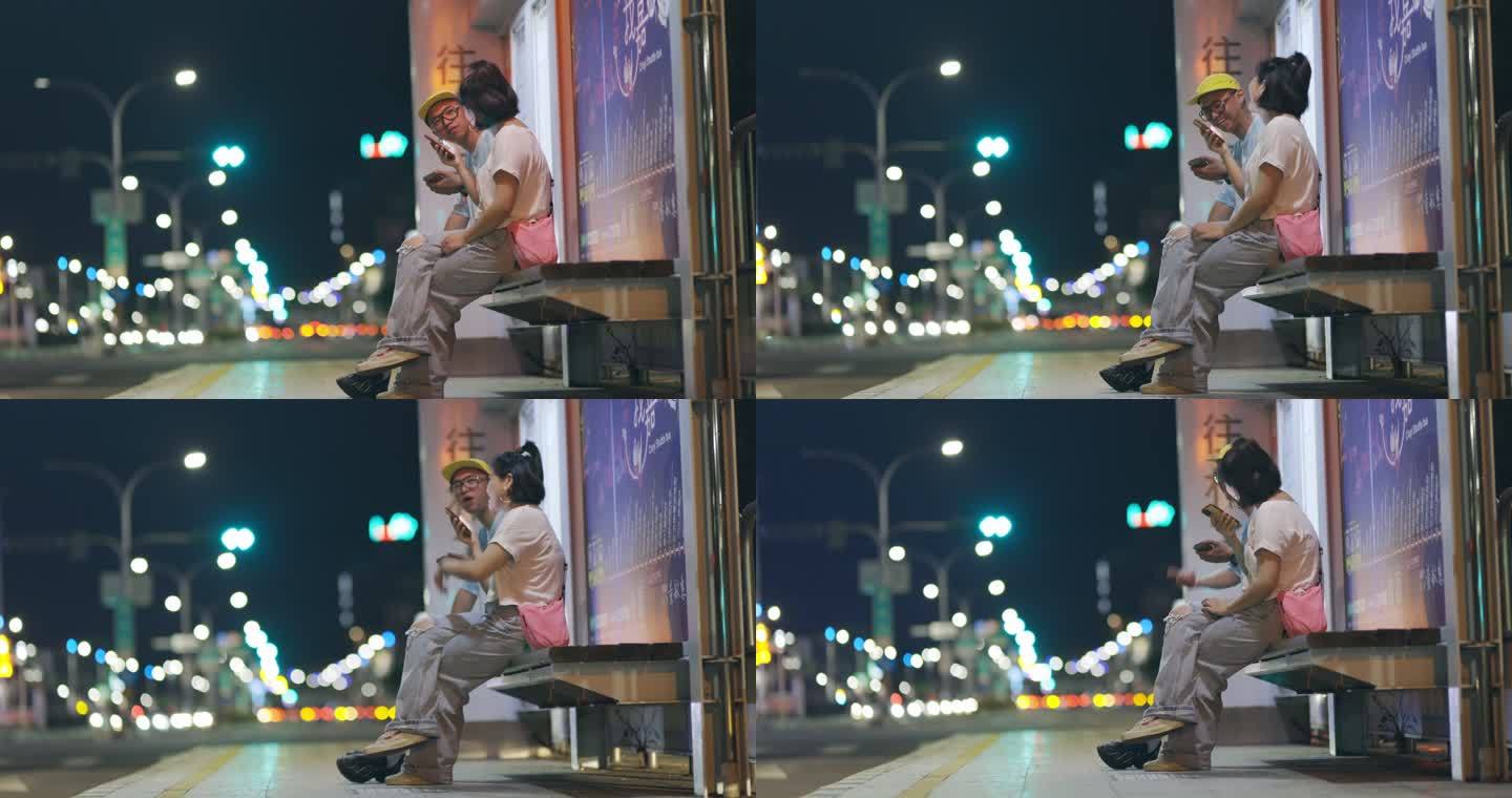 晚上在公共汽车站等公共汽车的亚裔男女