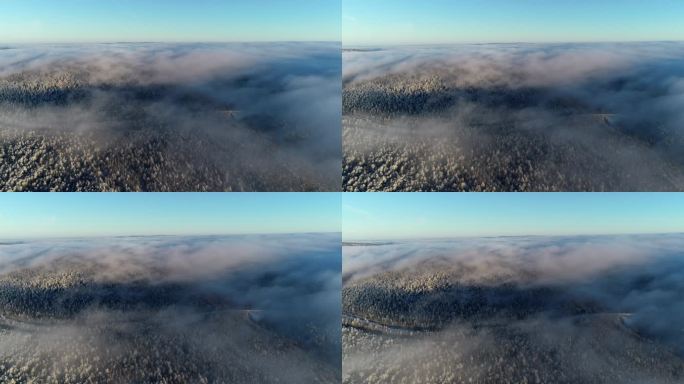 航拍云雾缭绕的冬季山林雾凇