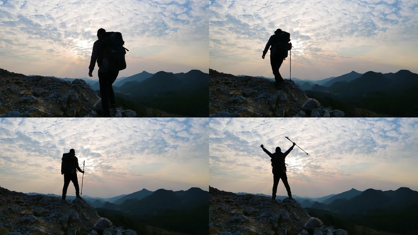 男人背着登山包爬山背影登上山顶攀登山峰