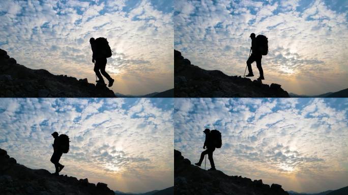 男人登山剪影背包客向山顶出发登山运动爬山