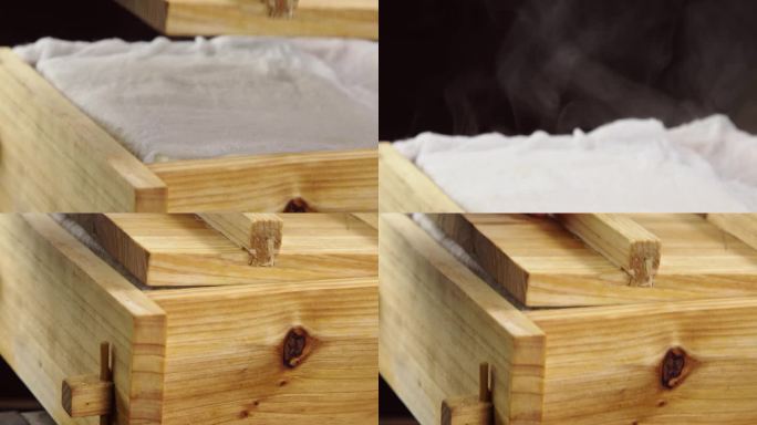 做豆腐的木盒子被拿起盖子冒着热气