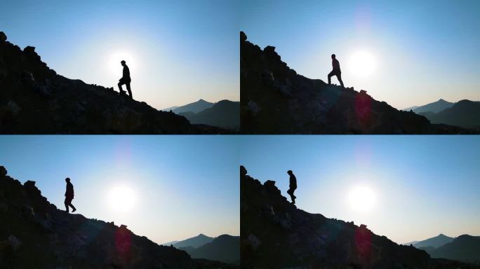 男人走向山顶登山剪影逆光人物眺望远方爬山