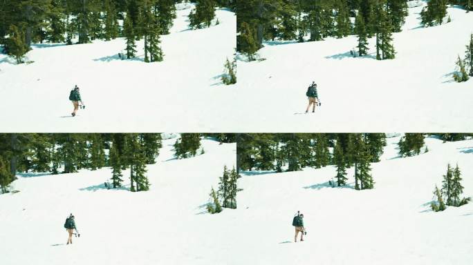 摄影师在冬季山区用三脚架拍摄视频