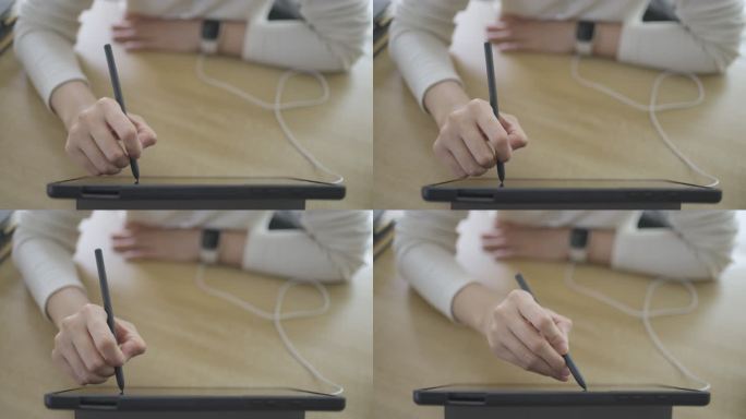 在数字平板电脑上使用数码笔的手特写