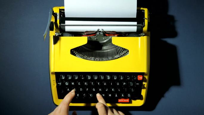 手在打字机上打字老式打字机旧式机械键盘古