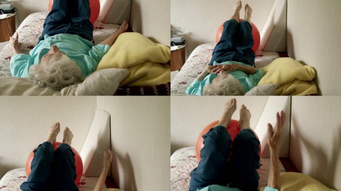 老年高加索妇女躺在床上用健身球进行日常锻炼，以保持健康、灵活和强壮