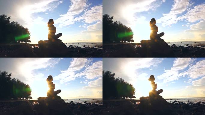 日落时在海滩上练习瑜伽的慢动作