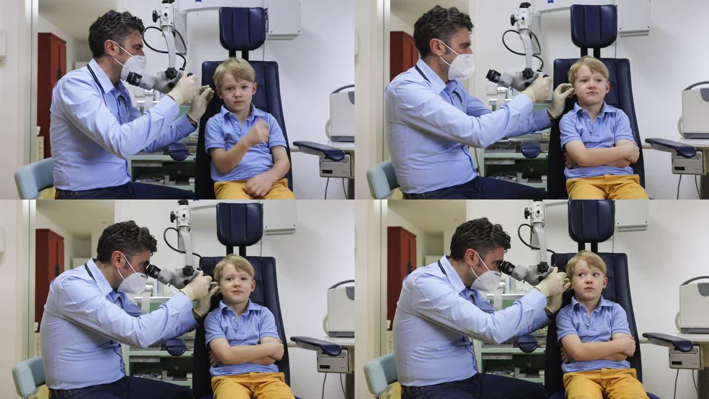 儿科医生检查男孩的耳朵