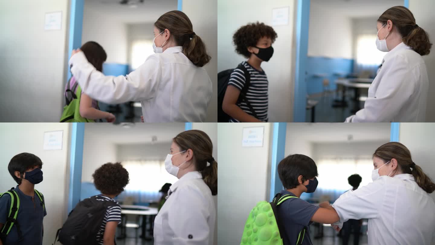 孩子们在教室里用肘撞老师——戴口罩