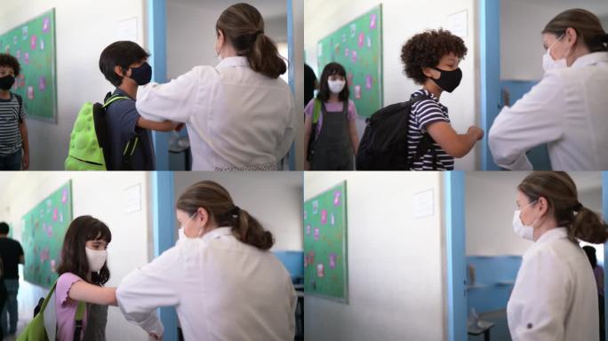 孩子们在教室里用肘撞老师——戴口罩