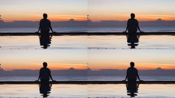 早晨游泳池上的影子反射着坐在海上看日出的女人的剪影