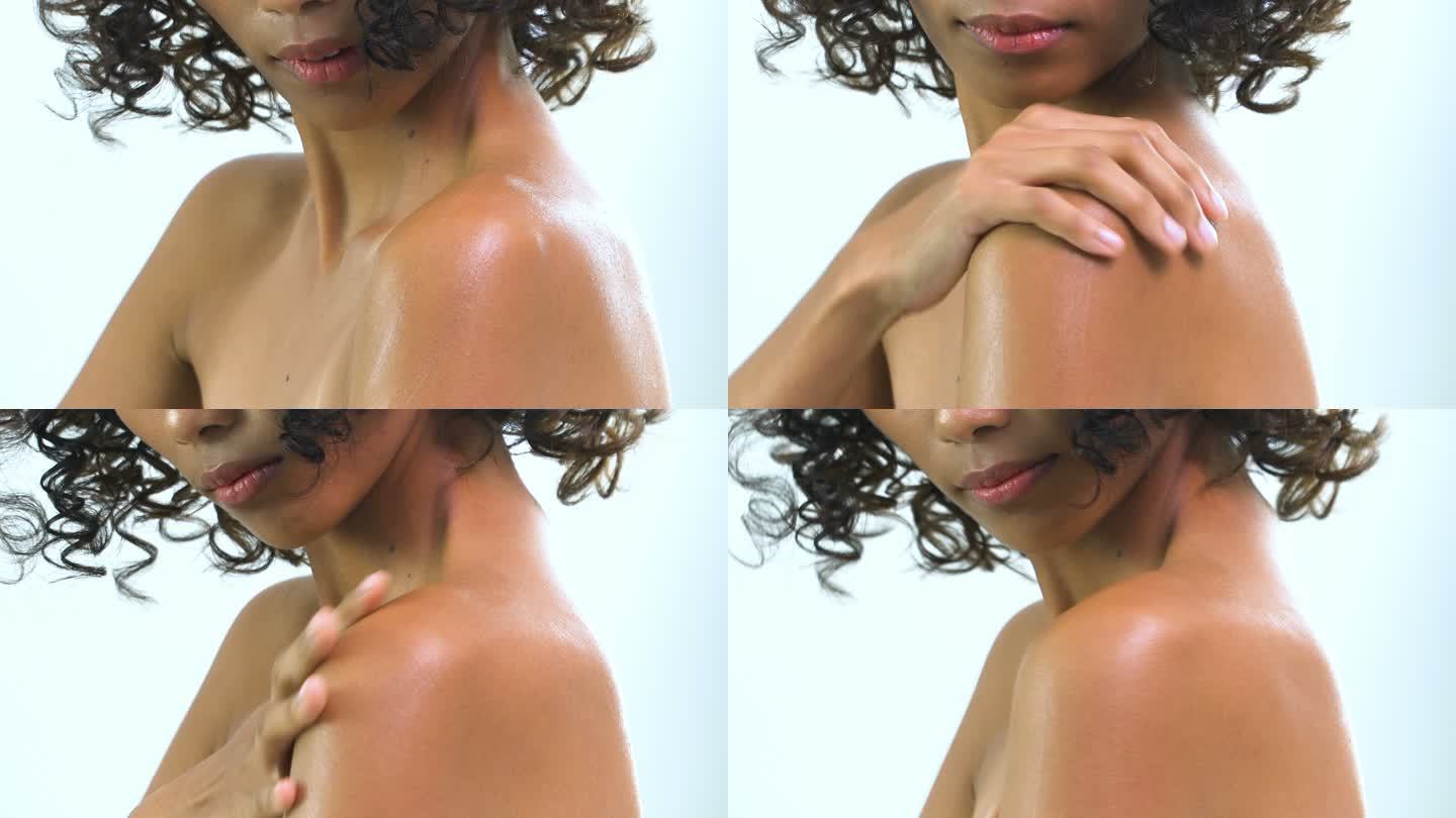 亚洲美丽的棕褐色女人在白色背景上涂乳液的肩膀特写。有美容、保健、情感观念的人。