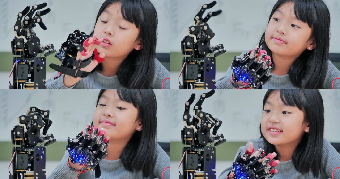 女孩在计算机上构建和编程，并将机器人手臂作为学校的科学项目。她对自己的工作非常满意。教育、技术、团队