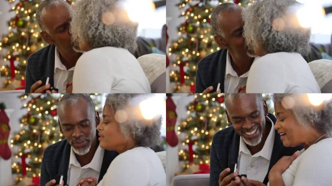 非洲裔美国老夫妇交换圣诞礼物后接吻