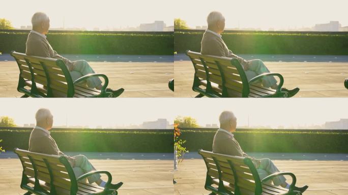 老年人公园座椅晒太阳背影