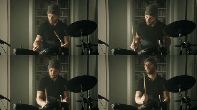 一名男子在客厅练习电子鼓。前视图