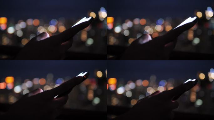 嬉皮士在城市夜晚使用智能手机