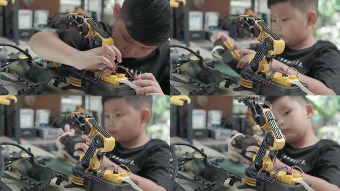 教育主题：数字平板电脑上的男孩控制机器人手臂，科学工程，教育，技术