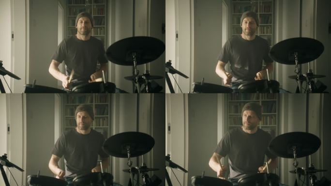 一名男子在客厅练习电子鼓。前视图