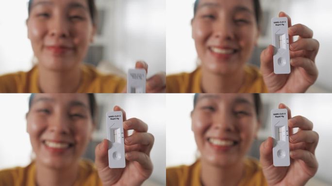 亚洲女性持有新冠肺炎冠状病毒自检试剂盒