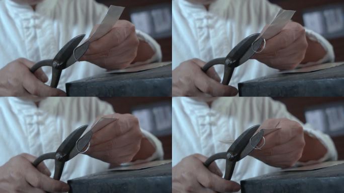 手工艺视频手工匠人锻银雕刻剪切银板慢镜头